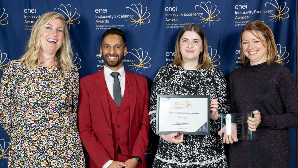 Representatives of National Highways posing with Bobby Seagull in front of the enei awards banner