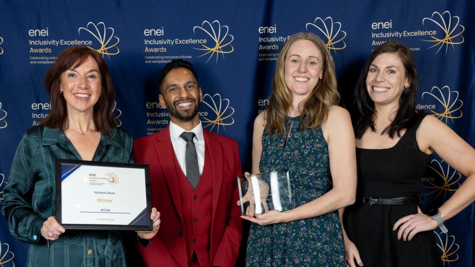 AECOM and Bobby Seagull posing for the camera in front of the enei awards banner