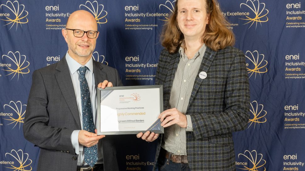 Award winners pose against the enei awards backdrop