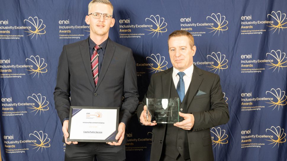 Award winners pose against the enei awards backdrop