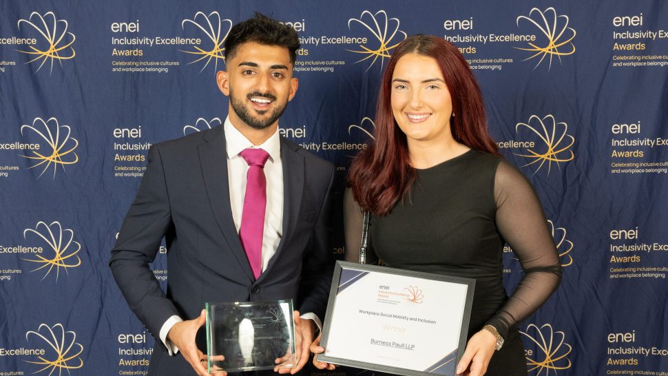 Award winners pose against the enei awards backdrop