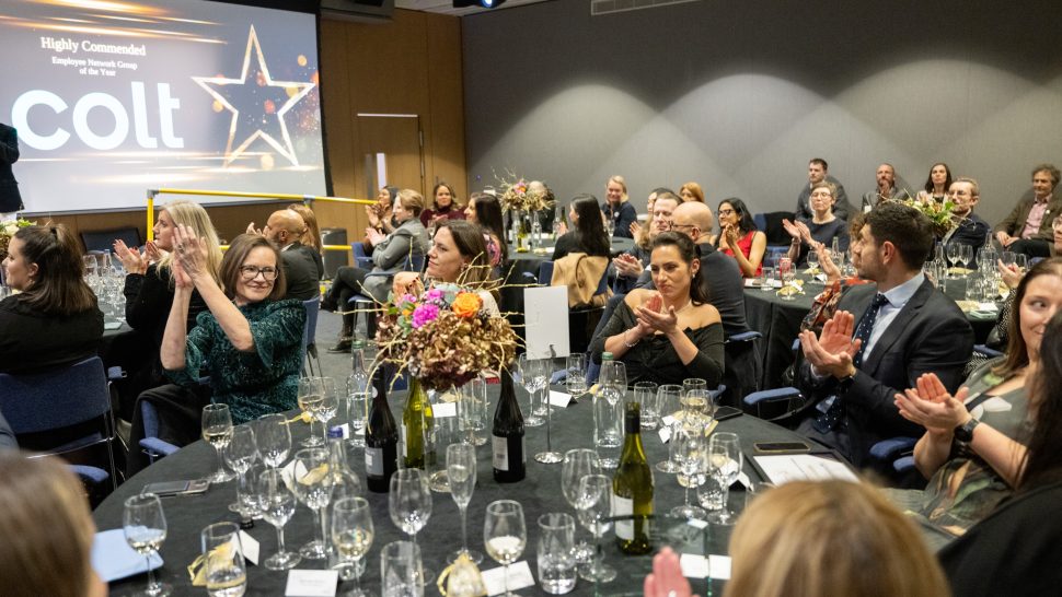 Image shows attendees clapping for the award winners as they go up to receive their award.