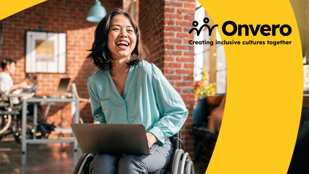 A young Asian female sits in a wheelchair in an office environment, holding a laptop on her knee, laughing at something off camera. The Onvero logo is in the corner.