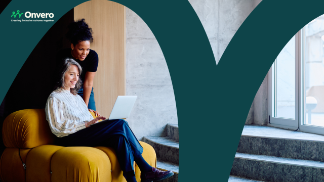 The image depicts two individuals collaborating. An older woman with grey hair is sitting comfortably on a sofa while using a laptop. Standing beside her is another woman, attentively engaged with the laptop screen. The Onvero logo is featured in the corner.